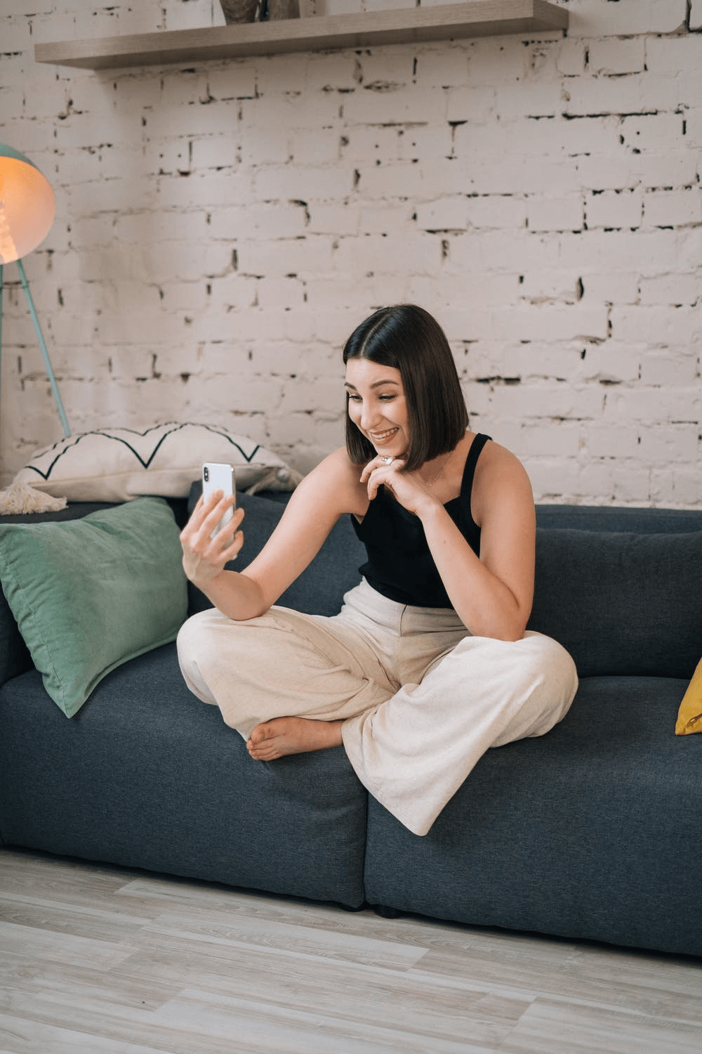 A Woman Sitting on a Couch Whilst Video Chatting